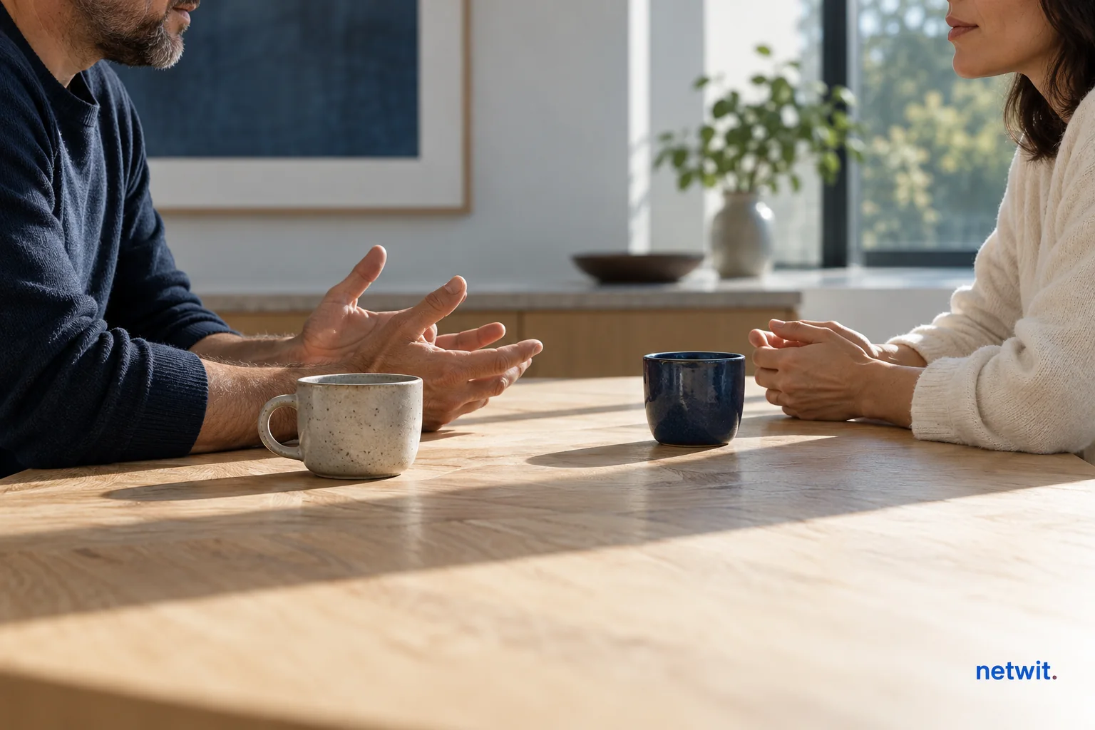 Two people talking calmly across a kitchen table.